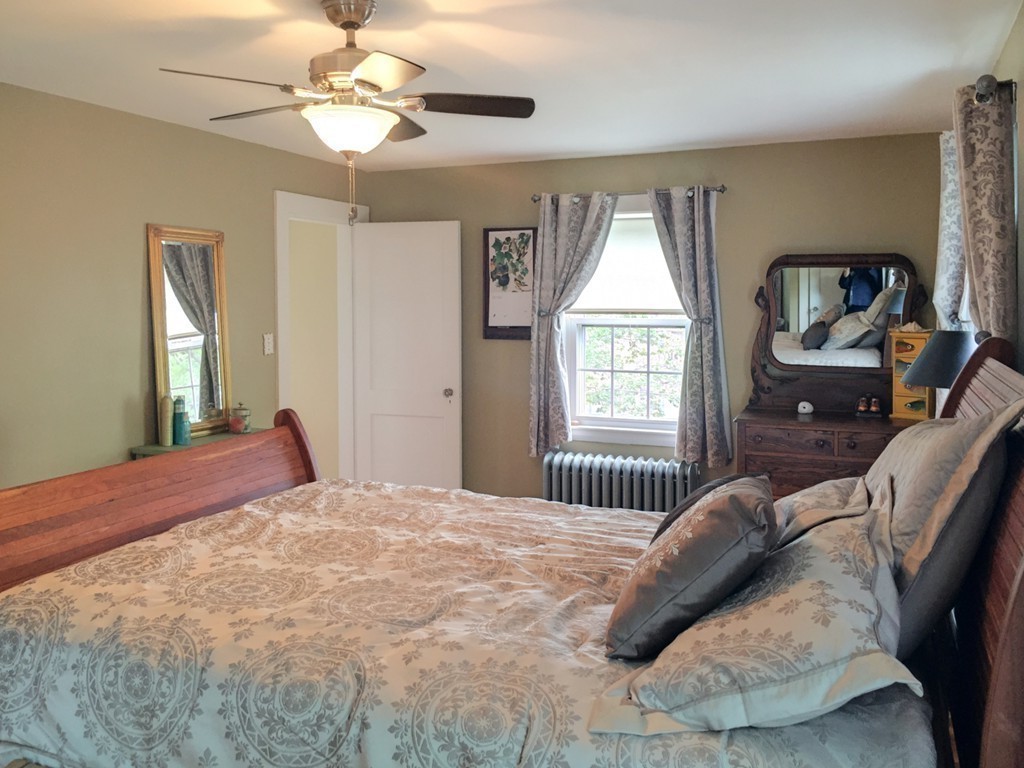 62 Edgehill Road Winthrop, MA 02152 - Photo 20 of 29 a bedroom with a bed and a chandelier