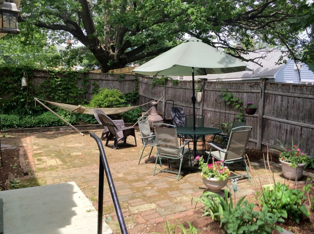 62 Edgehill Road Winthrop, MA 02152 - Photo 23 of 29 a view of a patio with chairs and table under an umbrella