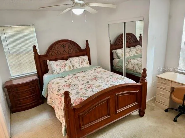 a bed sitting in a bedroom next to a window