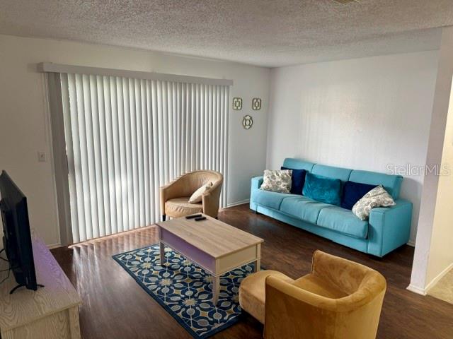 3705 Southwest 27th Street, Unit 1112 Gainesville, FL 32608 - Photo 3 of 23 a living room with furniture and a flat screen tv