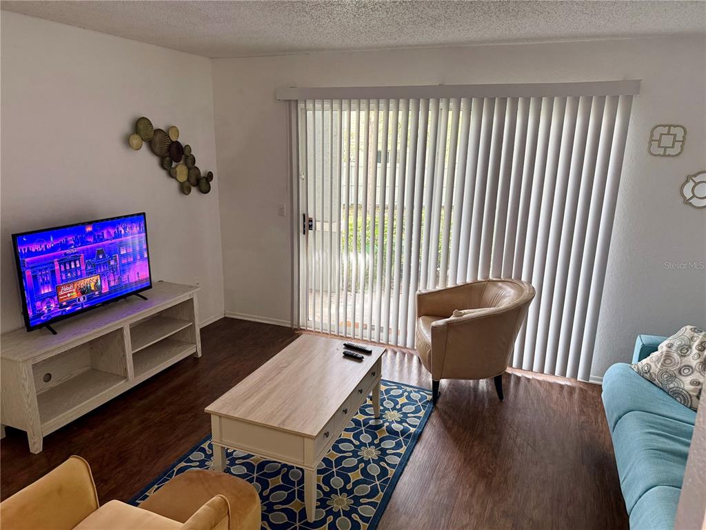 3705 Southwest 27th Street, Unit 1112 Gainesville, FL 32608 - Photo 4 of 23 a living room with furniture and a window