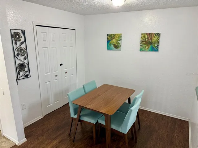 a view of a workspace with furniture and wooden floor
