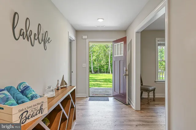 a view of a room with wooden floor and a window