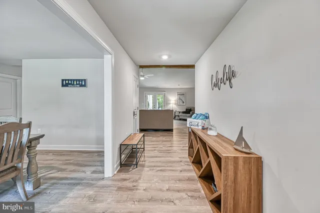 a view of a workspace with furniture and wooden floor