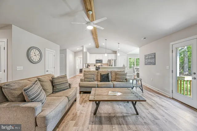 a view of a hallway with wooden floor and closet area
