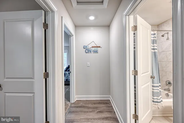 a bedroom with a bed and a flat tv screen on the dresser