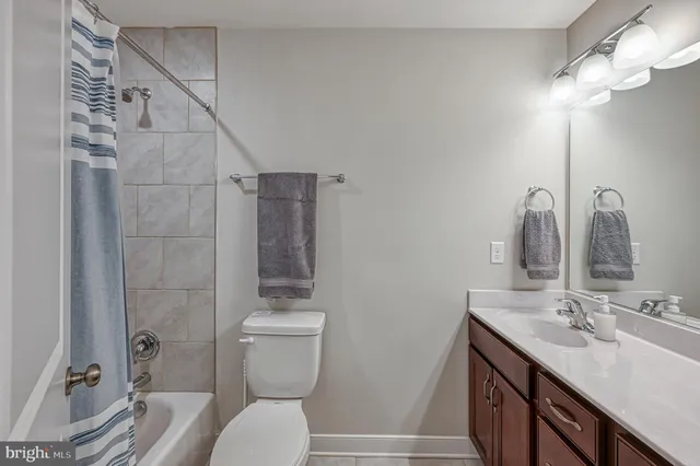 a bedroom with a bed a window and a flat screen television