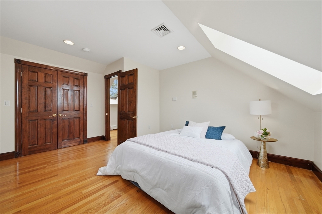 131 Range Heights Road Lynn, MA 01904 - Photo 19 of 36 a bedroom with a bed and wooden floor