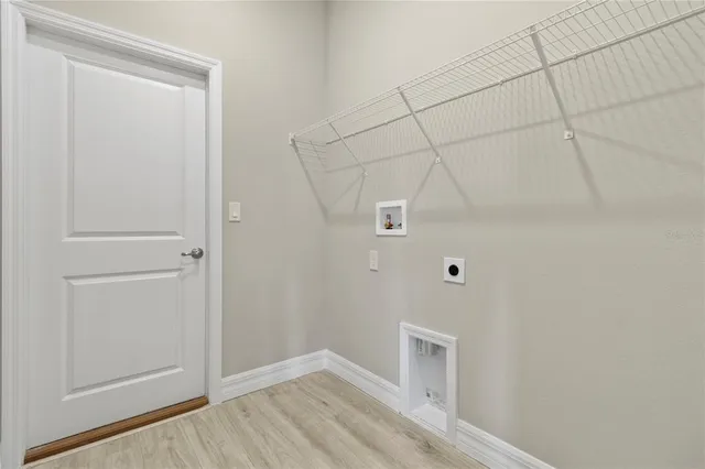 a view of a closet area with hardwood floor