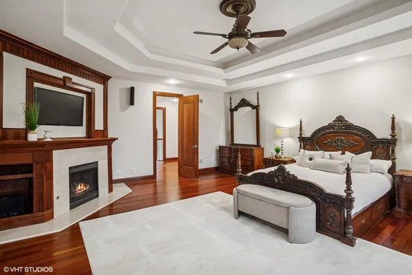 a spacious bedroom with a bed and a flat screen tv