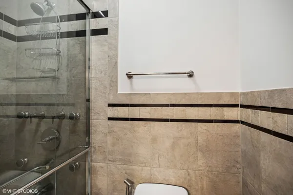 a bathroom with a shower and a sink