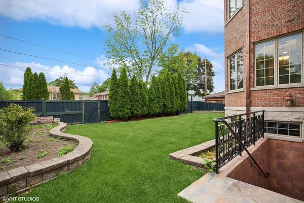 a front view of a house with a garden and plants