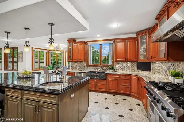 a kitchen with granite countertop a sink stove and cabinets
