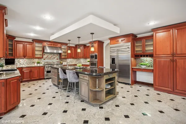 a kitchen with stainless steel appliances a stove a sink and a refrigerator