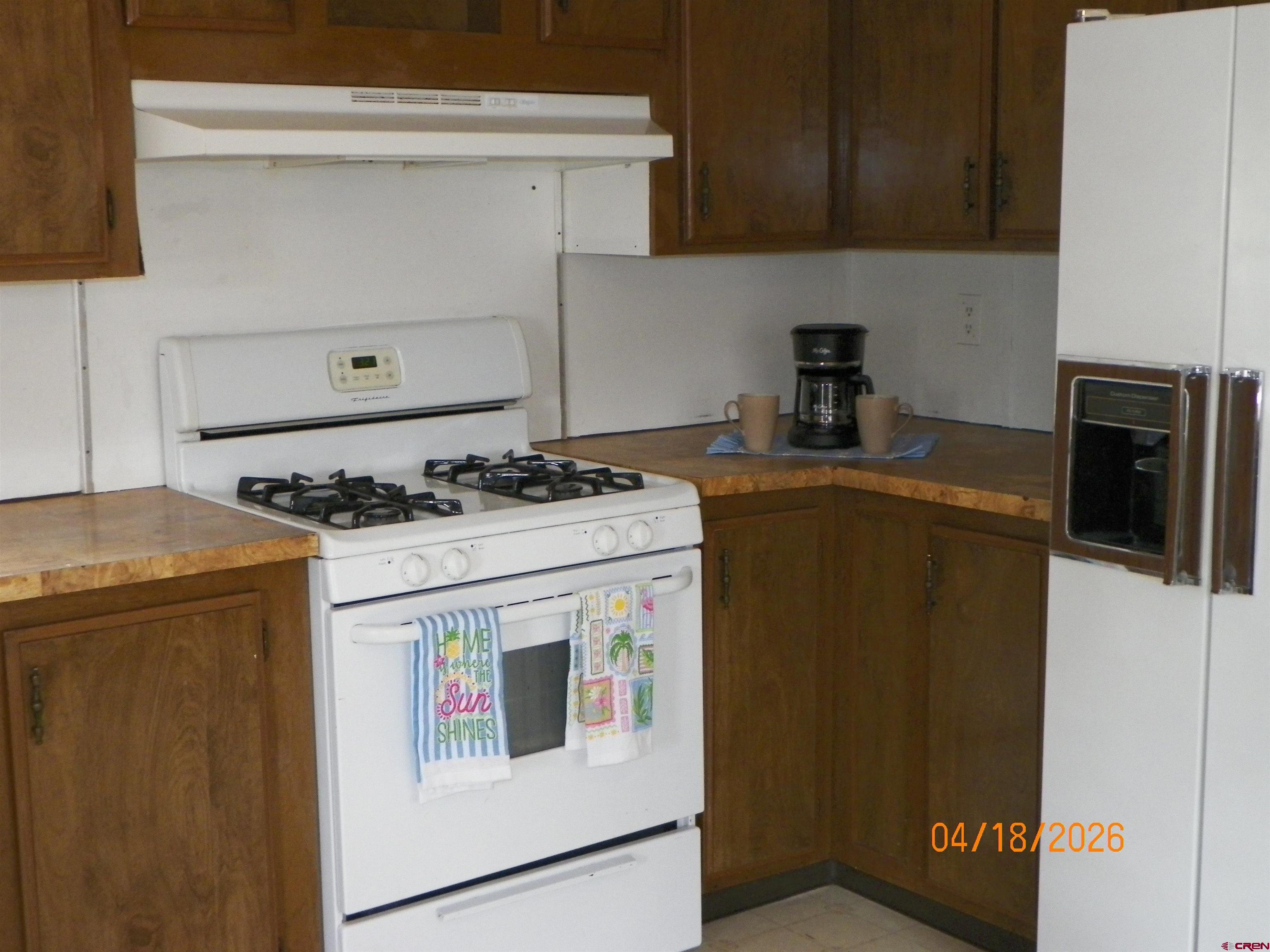 240 Southwest 13th Circle Cedaredge, CO 81413 - Photo 15 of 30 a kitchen with a stove and a refrigerator
