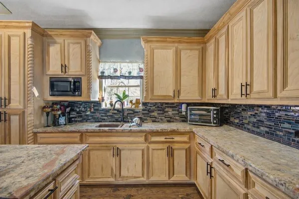 a kitchen with counter top space cabinets and stainless steel appliances