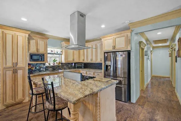 a kitchen with a table chairs refrigerator and cabinets