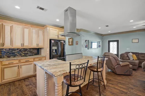 a kitchen with stainless steel appliances granite countertop a stove and a table