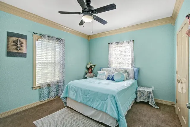 a bedroom with a bed table and closet