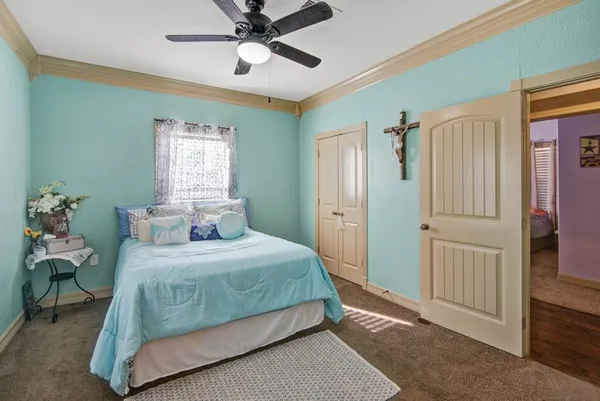 a bedroom with a bed and a chandelier