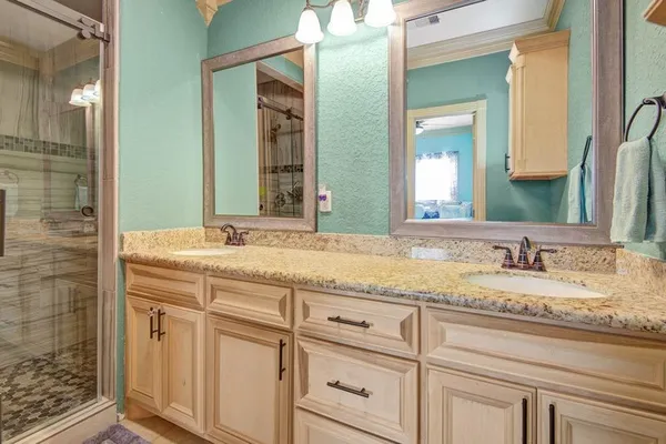 a bathroom with a granite countertop toilet sink and mirror
