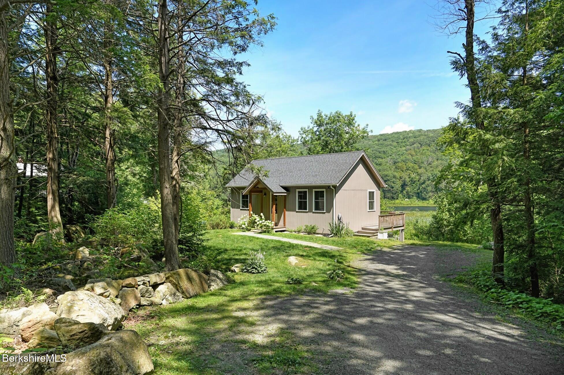 a view of a house with yard and a large tree