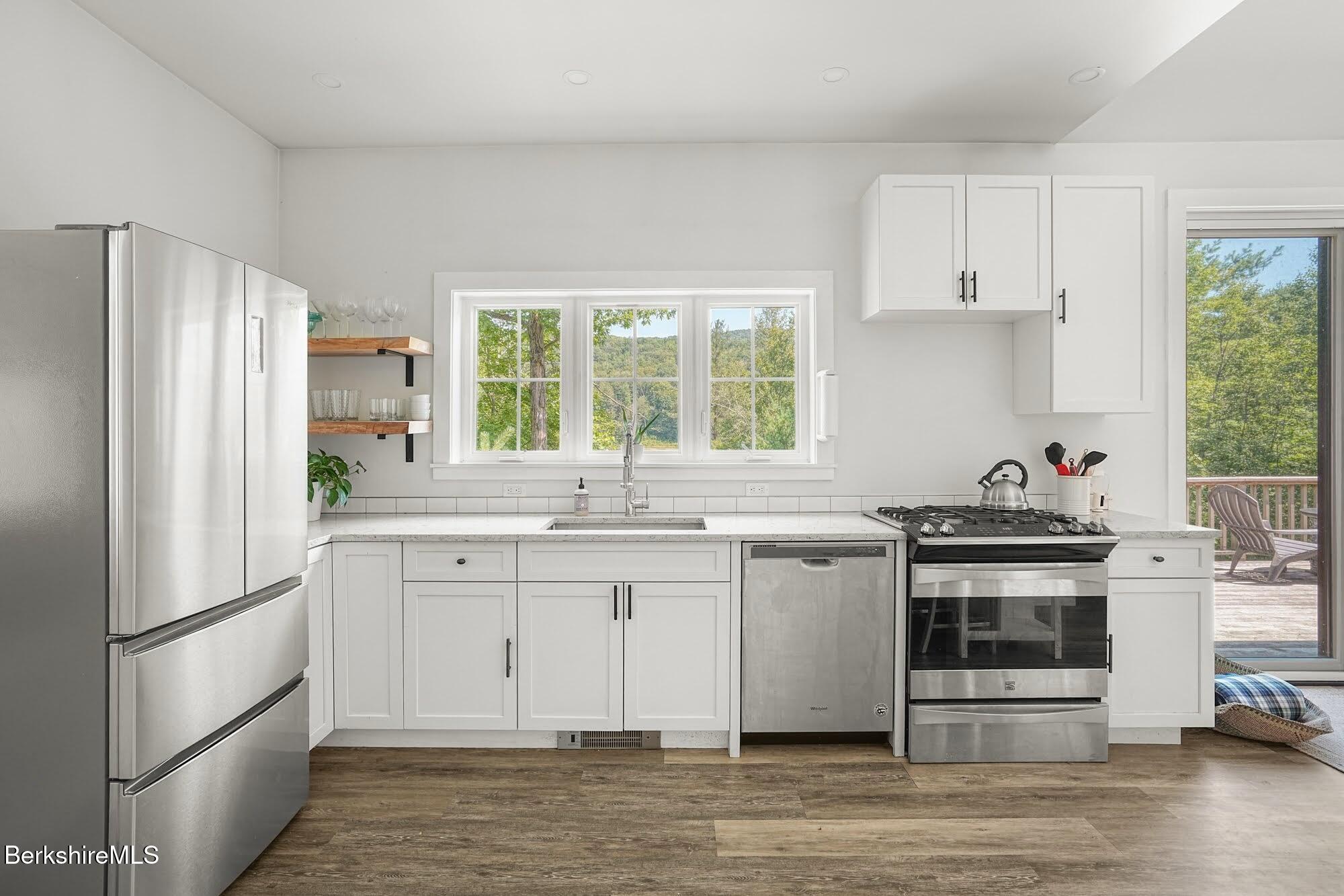 140 Beaver Dam Road Lee, MA 01238 - Photo 12 of 29 a kitchen with stainless steel appliances a stove a sink and a refrigerator