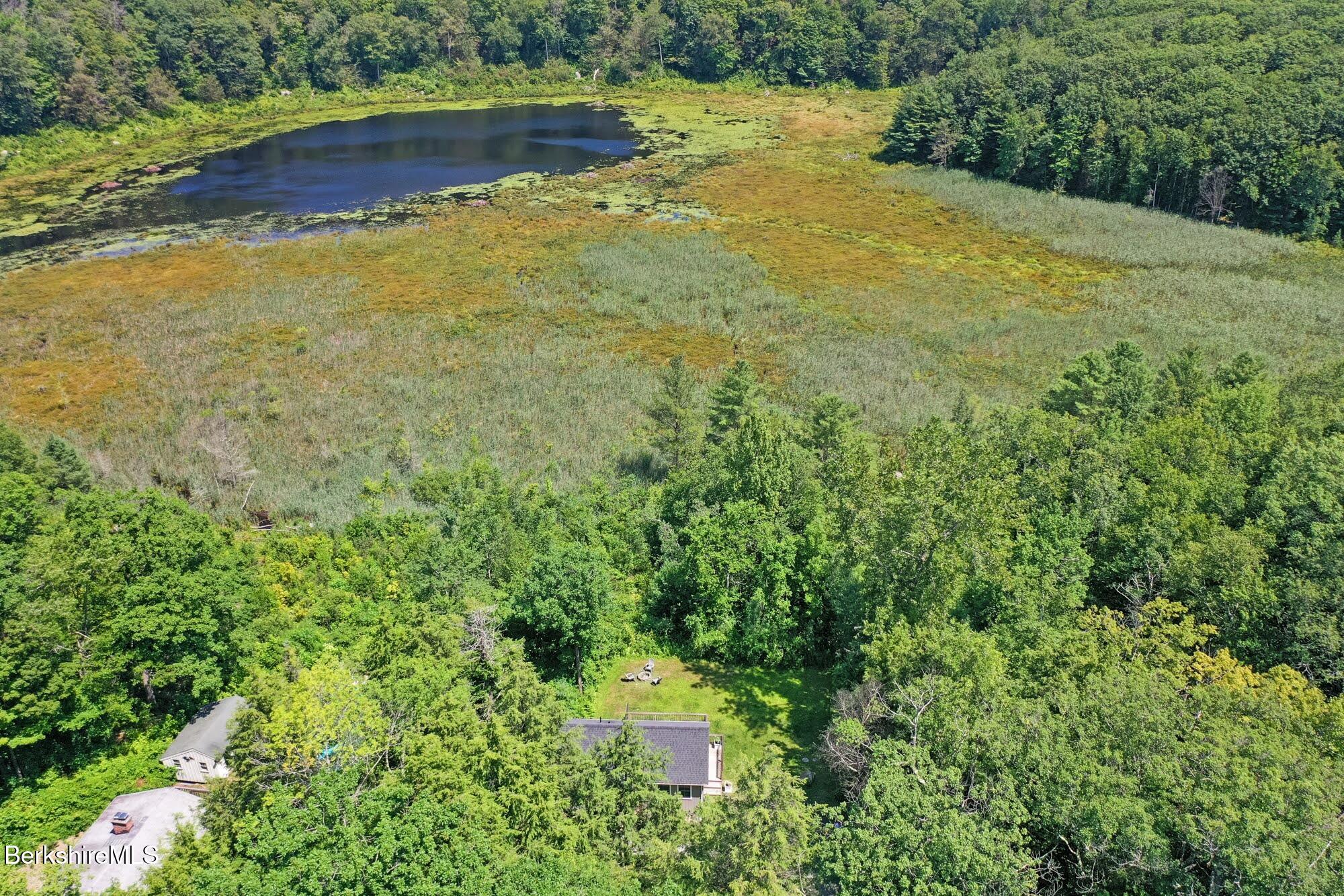 140 Beaver Dam Road Lee, MA 01238 - Photo 24 of 29 a view of a lake with a yard