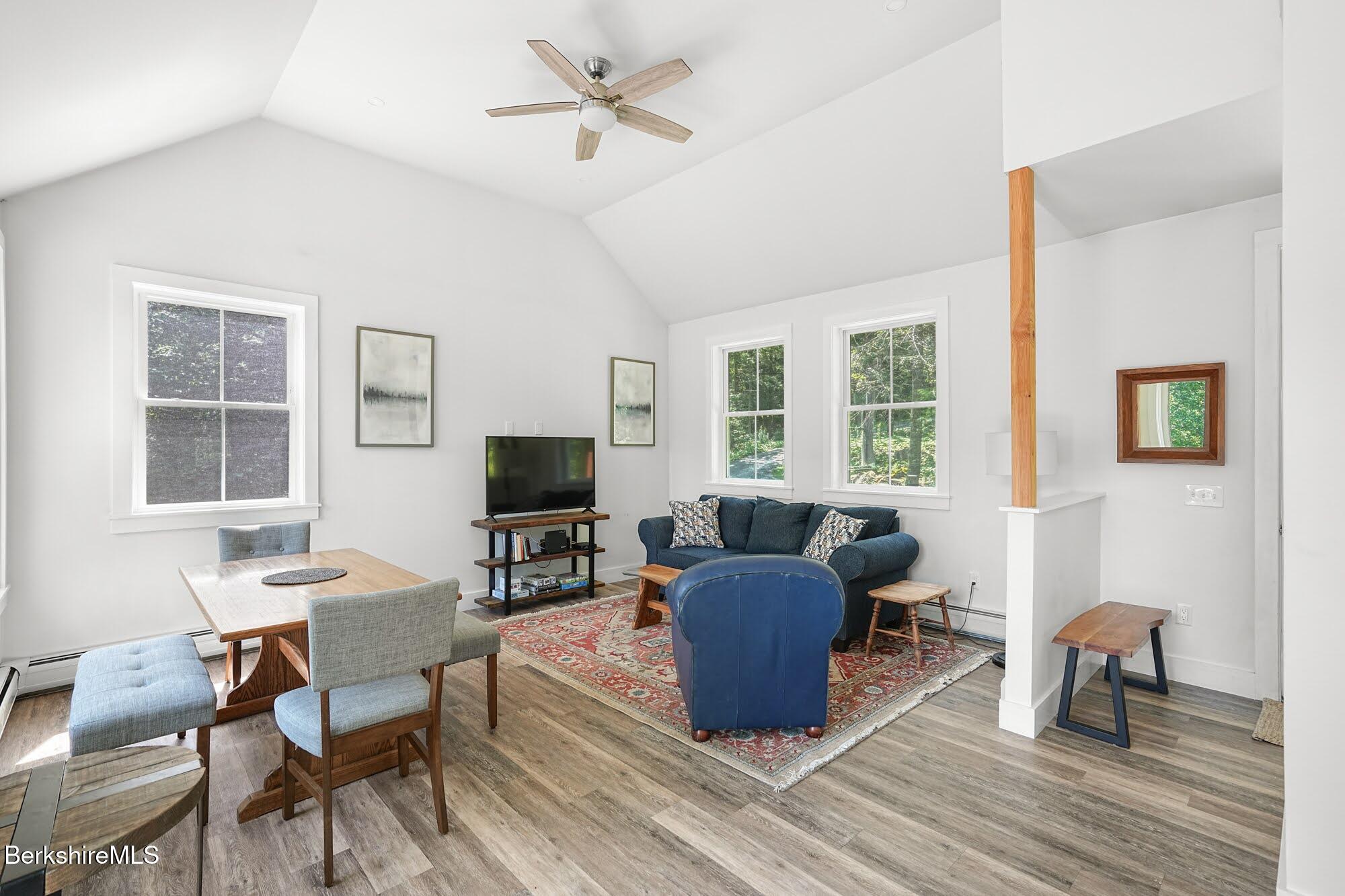 140 Beaver Dam Road Lee, MA 01238 - Photo 7 of 29 a living room with furniture a flat screen tv and windows