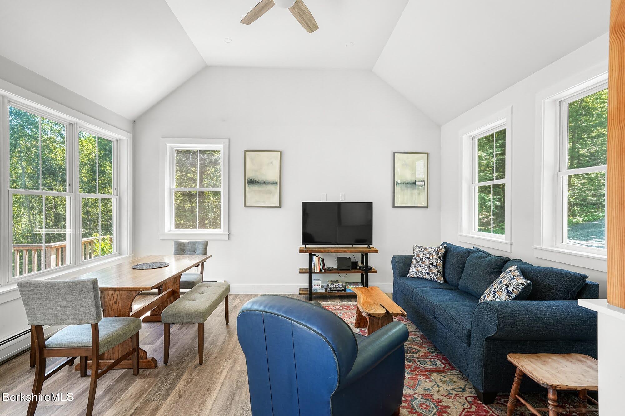 140 Beaver Dam Road Lee, MA 01238 - Photo 8 of 29 a living room with furniture a flat screen tv and a window