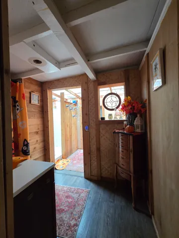 a bed sitting in a bedroom next to a window