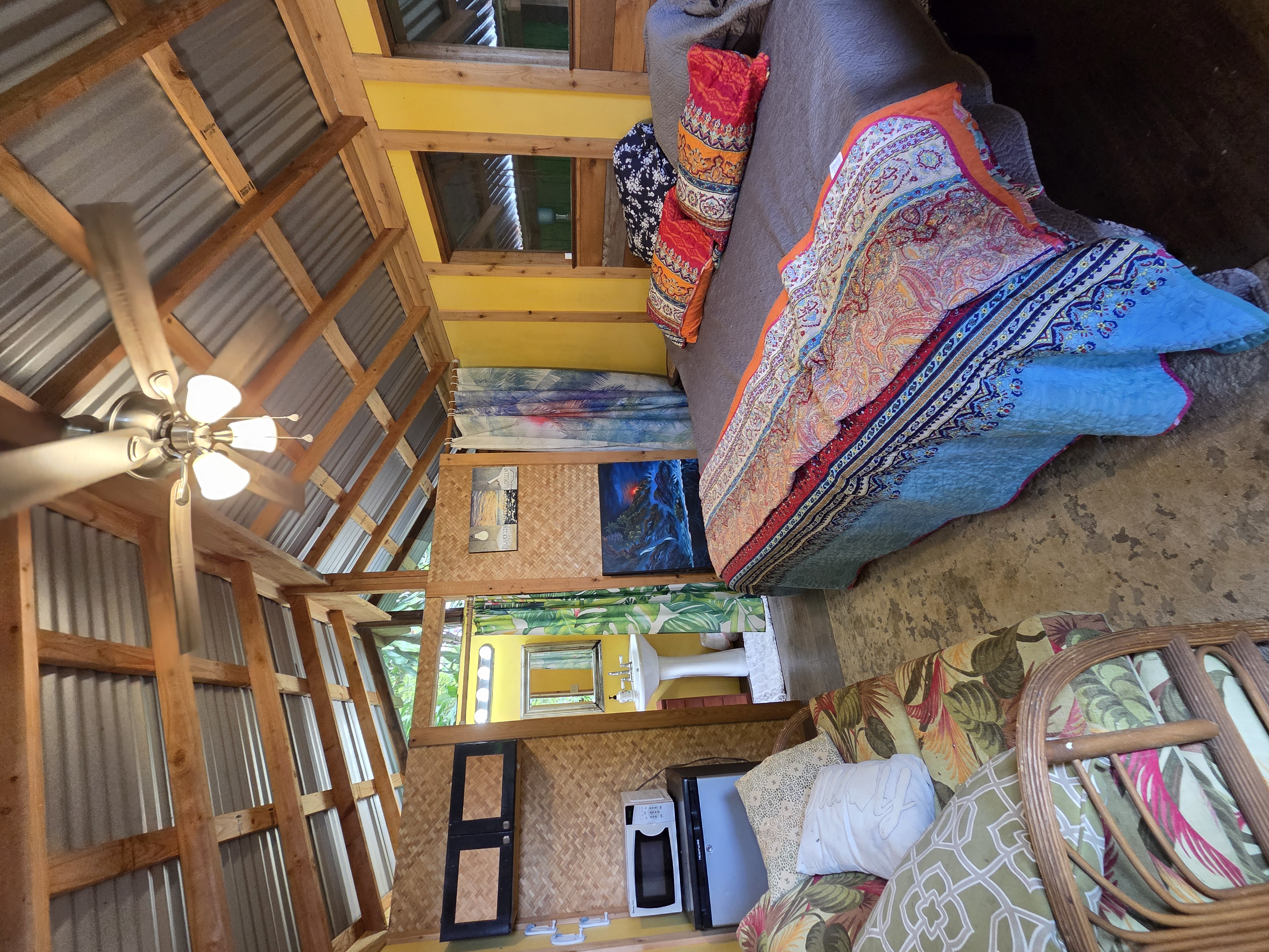 83-5782 Napoopoo Road Captain Cook, HI 96704 - Photo 23 of 30 a bed sitting in a bedroom next to a window