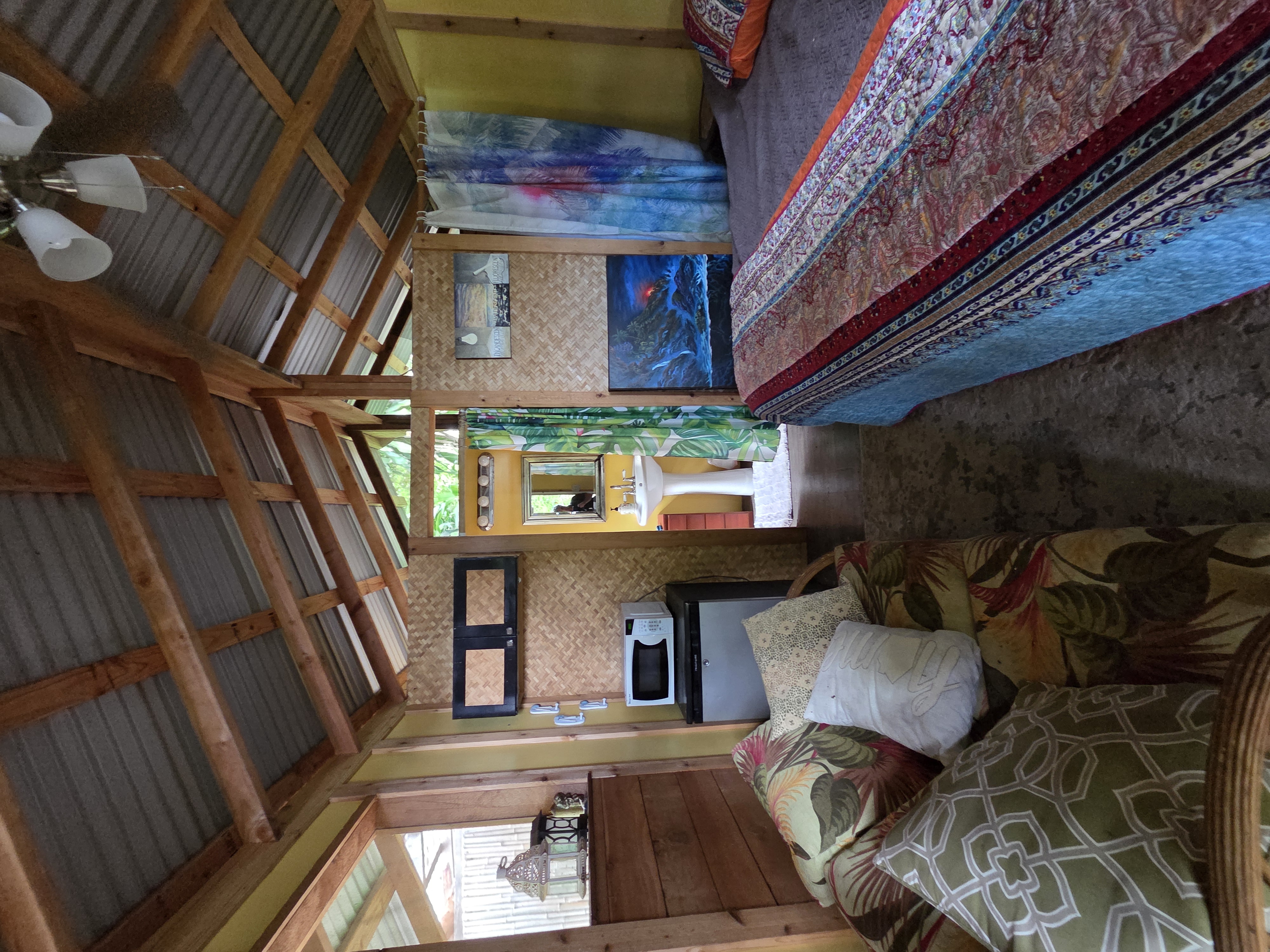 83-5782 Napoopoo Road Captain Cook, HI 96704 - Photo 25 of 30 a bed sitting in a bedroom next to a window