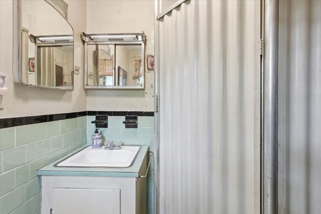 99 Brook Road Sharon, MA 02067 - Photo 22 of 37 a bathroom with a sink a mirror and a shower curtain