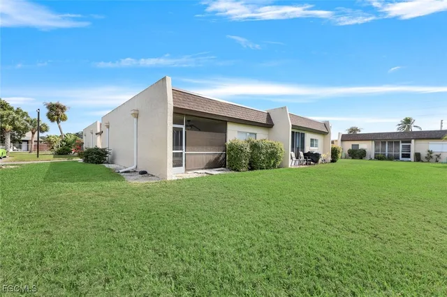 a view of an house with backyard space and garden