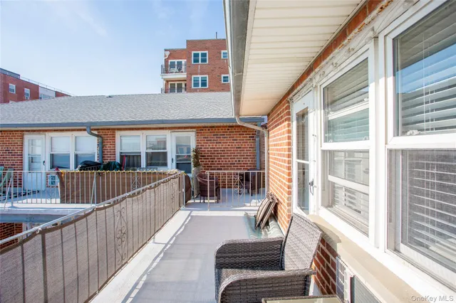 a living room with furniture and a refrigerator