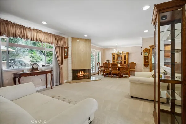 a bedroom with furniture and a large window