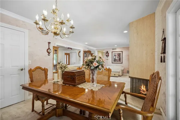 a living room with furniture wooden floor and a kitchen view
