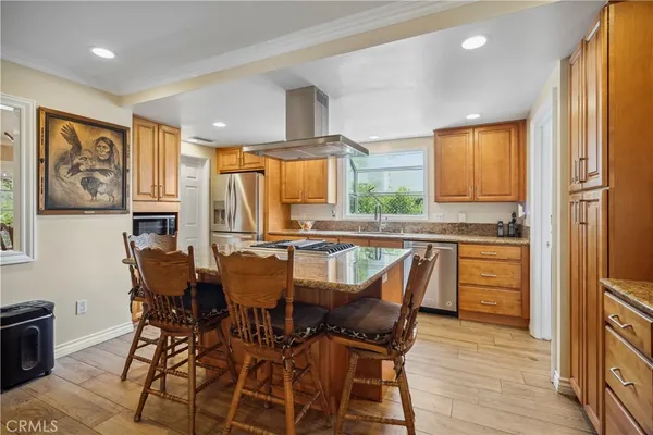 a kitchen with stainless steel appliances granite countertop a stove and a refrigerator