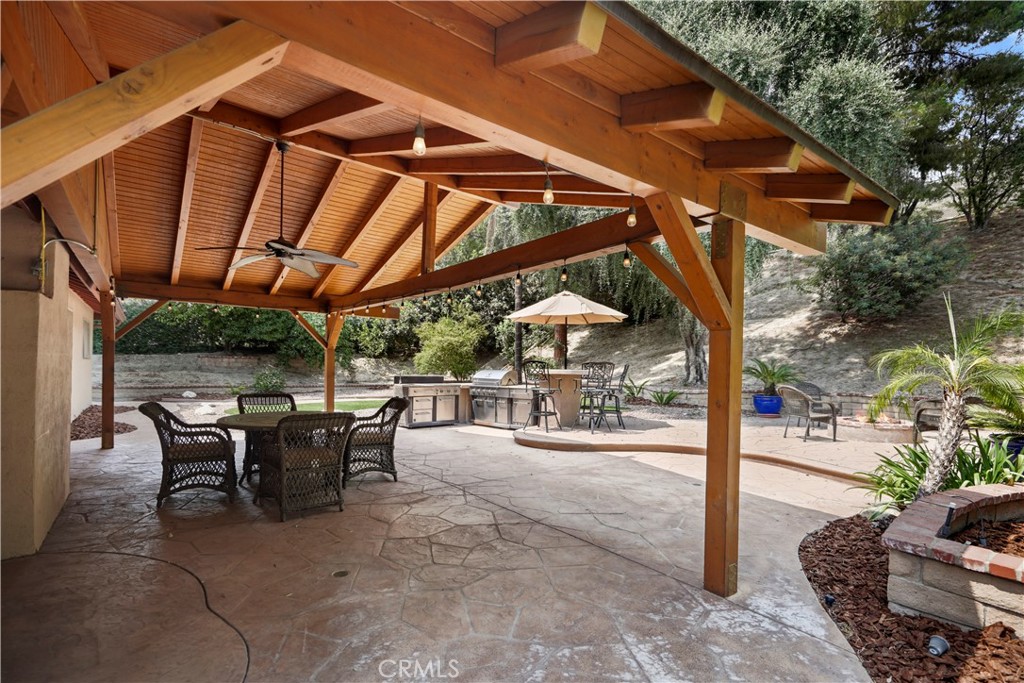 11300 Dulcet Avenue Porter Ranch, CA 91326 - Photo 51 of 55 a view of a patio with table and chairs under an umbrella