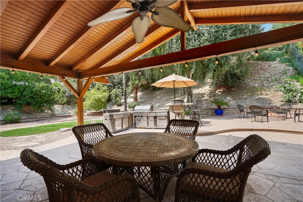 11300 Dulcet Avenue Porter Ranch, CA 91326 - Photo 52 of 55 a view of a patio with a table chairs and a wooden floor