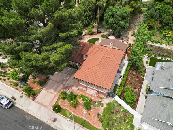 a view of a hallway with wooden floor and a living room