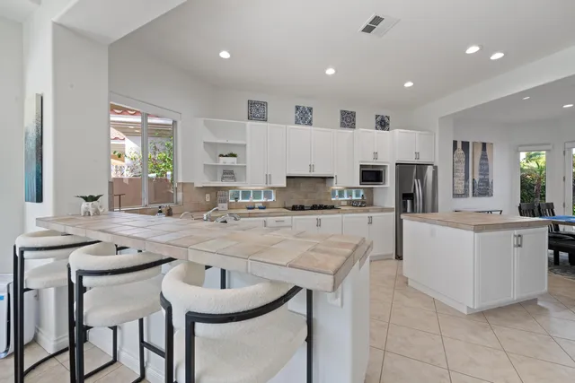 a dining table with chairs and window