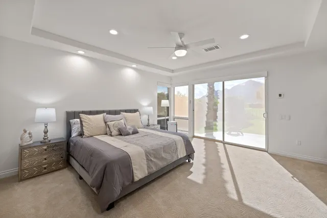 a bedroom with a large bed and a large window