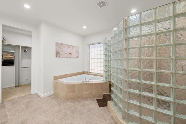 a bathroom with a bathtub and a shower