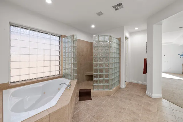 a bathroom with a bathtub and a shower