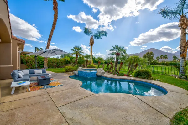 a view of a swimming pool and lounge chair