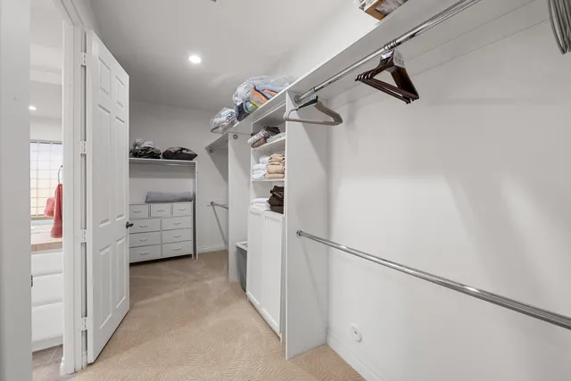 a view of walk in closet with white walls