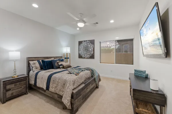 a spacious bedroom with a large bed and a dresser