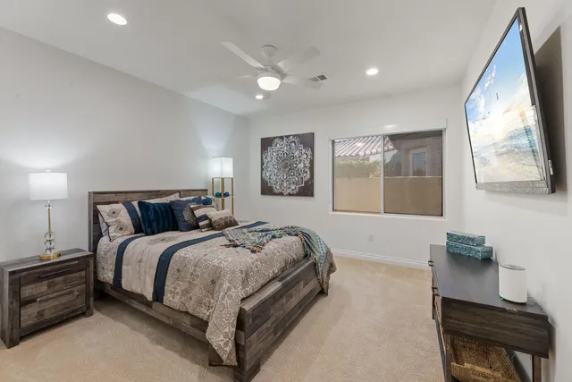 a spacious bedroom with a large bed and a dresser